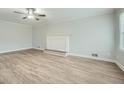 Spacious living room featuring light gray walls, fireplace and light wood laminate flooring at 1523 Pangborn Station Dr, Decatur, GA 30033