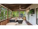 Covered back porch offering outdoor seating, a fan, and views of the landscaped backyard at 4771 Pinefield Nw Dr, Acworth, GA 30102