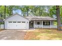 Charming home featuring a front porch, two-car garage, and well-maintained landscaping at 4771 Pinefield Nw Dr, Acworth, GA 30102