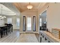 Inviting foyer with a stylish rug, decorative lighting, and views to dining room and office at 1550 Misty Valley Dr, Lawrenceville, GA 30045