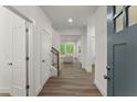 Bright entryway with hardwood floors, leading into a spacious living area with natural light at 216 Creek View Pl, Canton, GA 30114