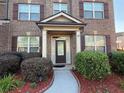 Up close image of the front door with brick exterior, manicured bushes, and mulch at 3670 Kissell Dr, Cumming, GA 30041