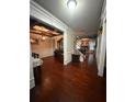 Open-concept living space with hardwood floors, coffered ceilings, and elegant furnishings at 3670 Kissell Dr, Cumming, GA 30041