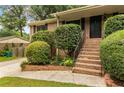 Beautiful brick home with lovely landscaping, brick steps, and a welcoming front entrance at 3916 Green Forest Se Ln, Smyrna, GA 30082