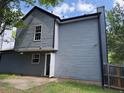 View of the back exterior showing the light gray vinyl siding, window, and access to yard at 615 Waynes Se Ct, Atlanta, GA 30354