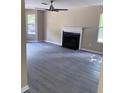 Cozy living room with a fireplace, wood-look floors, neutral walls, and natural light at 615 Waynes Se Ct, Atlanta, GA 30354