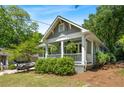 Charming craftsman-style home with a welcoming front porch and lush landscaping, perfect for relaxing and enjoying the outdoors at 1116 United Se Ave, Atlanta, GA 30316
