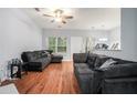 Cozy living room with hardwood floors, ceiling fan, and comfortable gray sofa, perfect for relaxing or entertaining at 2735 Snapfinger Mnr, Decatur, GA 30035