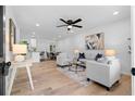 Bright open-concept living area features modern decor, hardwood floors, and recessed lighting at 2849 Knotty Pine Ct, Buford, GA 30519