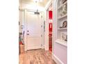View of entryway showcasing hardwood floors, a storage nook and view into a secondary room at 351 Ne Washington Ne Ave # 307, Marietta, GA 30060