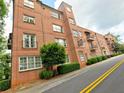 Building exterior with red brick, balconies and clock tower providing a stately look at 351 Washington Avenue at 351 Ne Washington Ne Ave # 307, Marietta, GA 30060