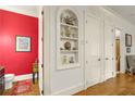 Hallway featuring built in shelving and doorways leading to adjacent rooms with hardwood flooring at 351 Ne Washington Ne Ave # 307, Marietta, GA 30060