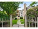 Inviting home exterior with a stone chimney, stepping stone pathway, and a charming picket fence at 132 East Ne Dr, Atlanta, GA 30305