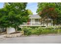 Attractive home exterior with a white picket fence adorned with flowering vines and a red front door at 132 East Ne Dr, Atlanta, GA 30305