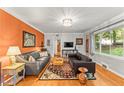 Bright living room featuring hardwood floors, stylish sofas, and a large window at 2511 Oak Ave, Tucker, GA 30084