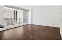 Bright living room with wood floors, natural light, and a balcony with city views at 620 Peachtree Ne St # 1716, Atlanta, GA 30308