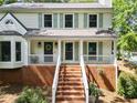 Attractive home exterior featuring a brick foundation, a covered front porch, and a bay window at 3306 Emory Dr, Marietta, GA 30062