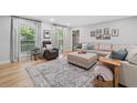 Bright living room with large windows, light wood floors, neutral decor, and comfortable seating at 3306 Emory Dr, Marietta, GA 30062