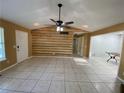 Spacious living room featuring tile flooring, ceiling fan, and a unique decorative wall at 50 Glenmore Dr, Kingston, GA 30145