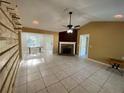 Bright living area with tile floors, fireplace, and access to a sunroom at 50 Glenmore Dr, Kingston, GA 30145
