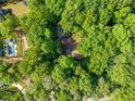 An aerial perspective showing the house and its heavily wooded lot at 5800 Mitchell Rd, Atlanta, GA 30328