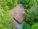 Aerial view of the roof of the property nestled among many tall and lush trees at 5800 Mitchell Rd, Atlanta, GA 30328