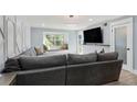 Modern living room with large sectional couch, window seat and stylish decor at 6851 Roswell Rd # K-23, Atlanta, GA 30328