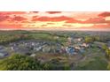 Scenic aerial view of a community with rolling hills and stunning sunset sky at 237 Laurel Vista Dr, Canton, GA 30114