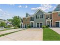 Charming townhome with a well-manicured lawn and attached garage at 5221 Sherwood Way, Cumming, GA 30040