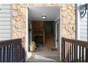 Condo entrance showcasing the wooden staircase and stone accent wall at 1102 Madison Ln # 1102, Smyrna, GA 30080