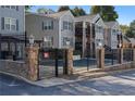 Community pool area features secure fencing and charming stone pillar accents at 1102 Madison Ln # 1102, Smyrna, GA 30080