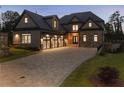 Beautiful stone home featuring a large driveway and a three-car garage, combining style and functionality at 4253 Biltmore Pl, Marietta, GA 30062