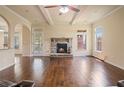 Spacious living room with stone fireplace, hardwood floors, and access to the backyard at 5805 Fielding Ct, Cumming, GA 30041