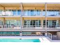 Contemporary building exterior featuring private balconies overlooking a sparkling community pool at 890 Memorial Se Dr # 105, Atlanta, GA 30316