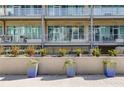 Building exterior showing well-manicured landscaping and private balconies with glass railings at 890 Memorial Se Dr # 105, Atlanta, GA 30316