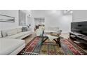 Cozy living room showcasing high ceilings, modern furniture and wood flooring at 907 Parkaire Xing, Marietta, GA 30068