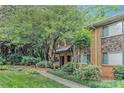 Inviting brick townhome with stone accents and lush landscaping, providing a serene and welcoming curb appeal at 100 Biscayne Nw Dr # A1, Atlanta, GA 30309