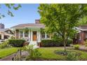 Inviting brick home featuring a quaint front yard, lush landscaping, and a welcoming front entrance at 239 Kings Hwy, Decatur, GA 30030