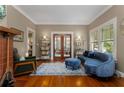 Bright living room showcasing hardwood floors, a decorative fireplace, and stylish blue furniture at 239 Kings Hwy, Decatur, GA 30030