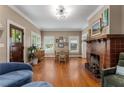 Cozy living room with fireplace, hardwood floors, and an abundance of natural light at 239 Kings Hwy, Decatur, GA 30030