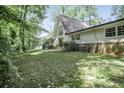 The rear exterior of the property offers an ample yard that is surrounded by trees at 2820 Georgian Ter, Marietta, GA 30068