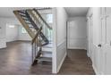 Bright and modern entryway with wood-look floors, a staircase, and neutral walls at 2820 Georgian Ter, Marietta, GA 30068
