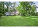 Beautiful home with a well-maintained lawn and mature trees, offering a serene and inviting curb appeal at 2820 Georgian Ter, Marietta, GA 30068
