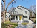 Charming two-story home with a welcoming front porch and a bright yellow door at 1560 Sarah M Harden Dr, Atlanta, GA 30311