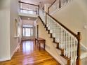 Bright foyer with hardwood floors, staircase with white railings, and natural light at 475 Vinings Estates Se Dr # A03, Smyrna, GA 30126