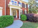 Close-up of front entry with brick facade, well maintained landscaping, and trimmed bushes at 475 Vinings Estates Se Dr # A03, Smyrna, GA 30126