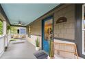 Inviting front porch with a blue ceiling, swing, and stylish decor, perfect for relaxing outdoors at 1063 Manigault Se St, Atlanta, GA 30316