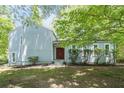 Inviting front facade with vibrant green lawn and mature shade trees at 3262 Bluff Rd, Marietta, GA 30062