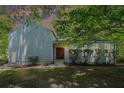 Inviting front facade with lush greenery and mature trees at 3262 Bluff Rd, Marietta, GA 30062