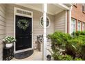 Inviting front porch with elegant wreath, potted plants, and cozy bench seating at 360 Parkview Manor Dr, Tucker, GA 30084